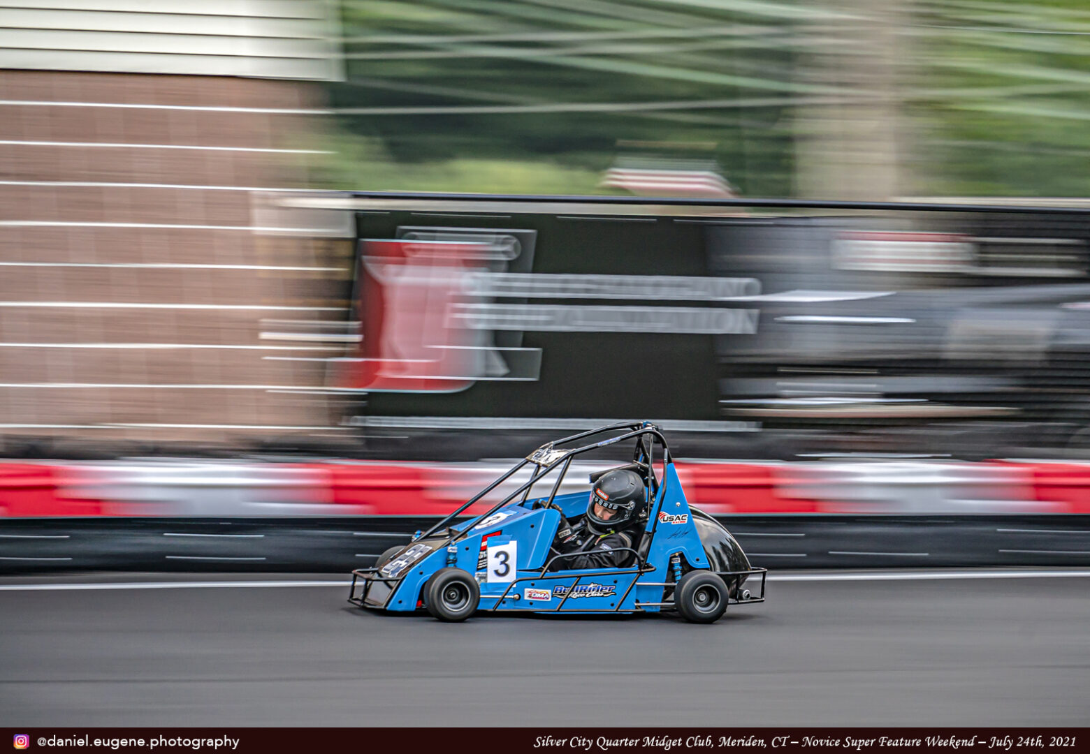 A Blue Color Kart Zooming on a Racing Track