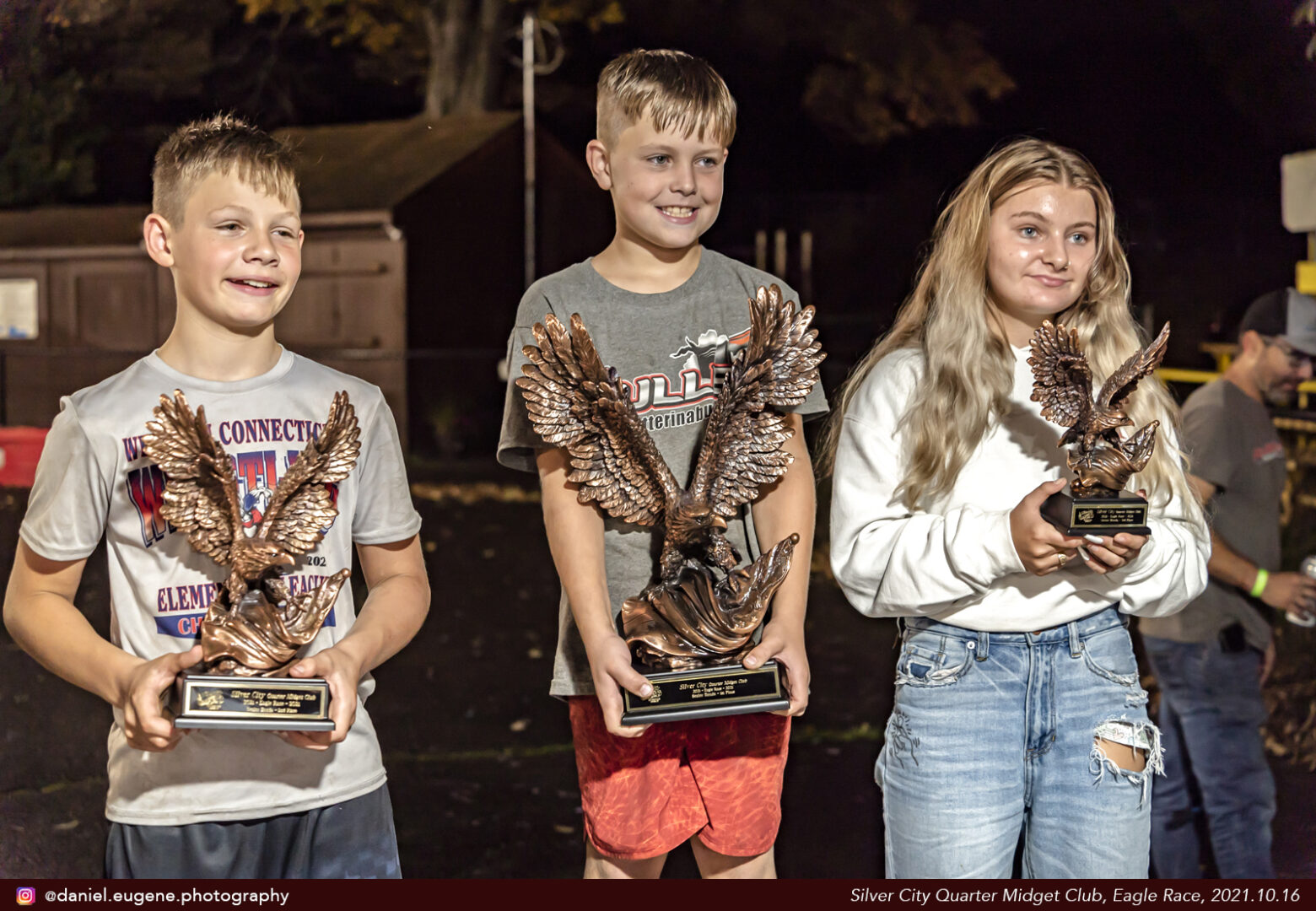 Two Boys and a Girl With Eagle Shaped Trophies