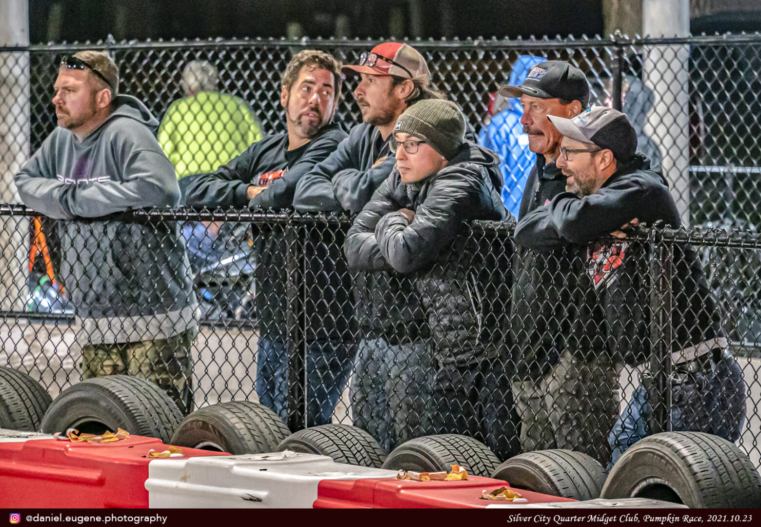 Parents Watching Over the Race From a Fence