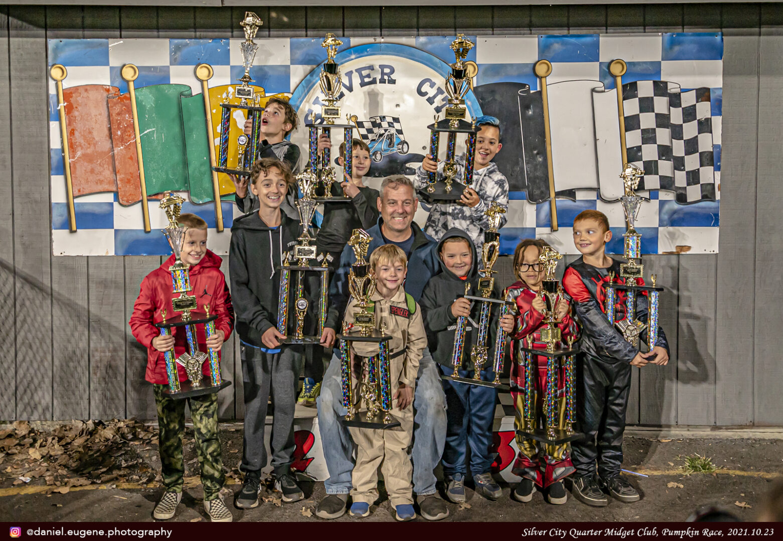 A Group of Kids Standing With a Trophy Along With a Man