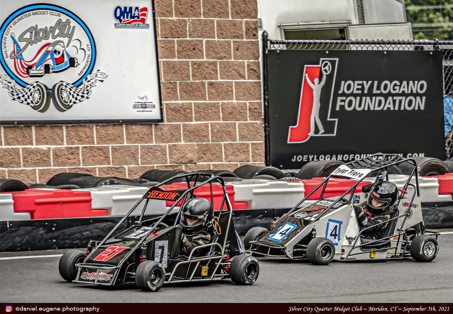 A Black and Grey Color Kart Racing With Each Other