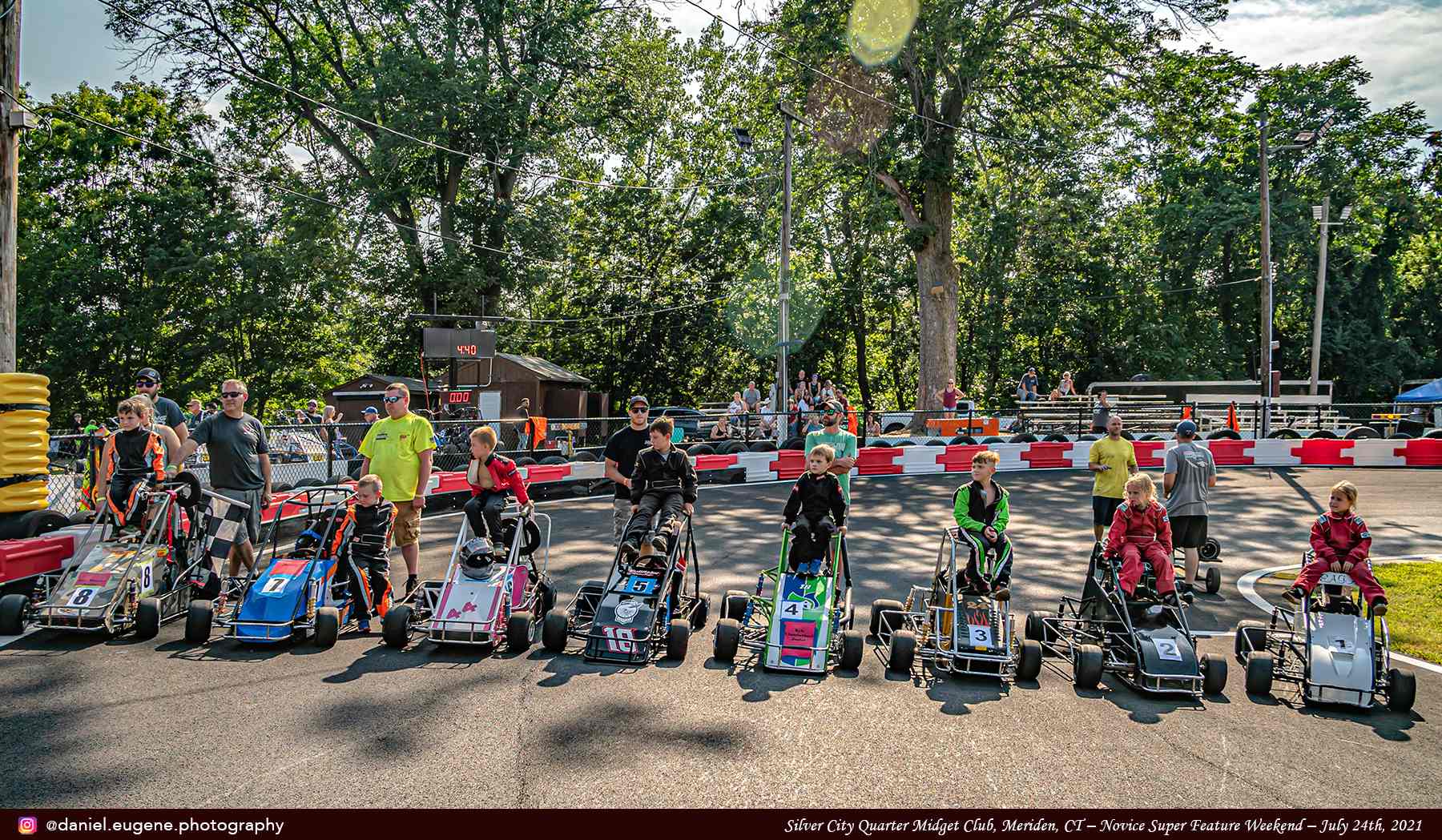 Kids Sitting on Karts of Different Colors Lined