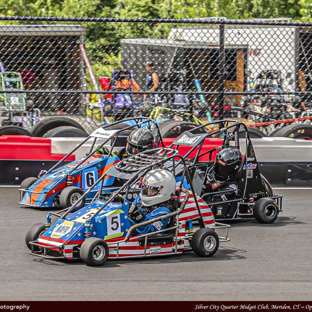 Kids in Kart Cars Racing With Each Other Side View Angle